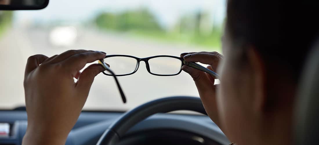 Man looking through glasses (Behind the Wheel)