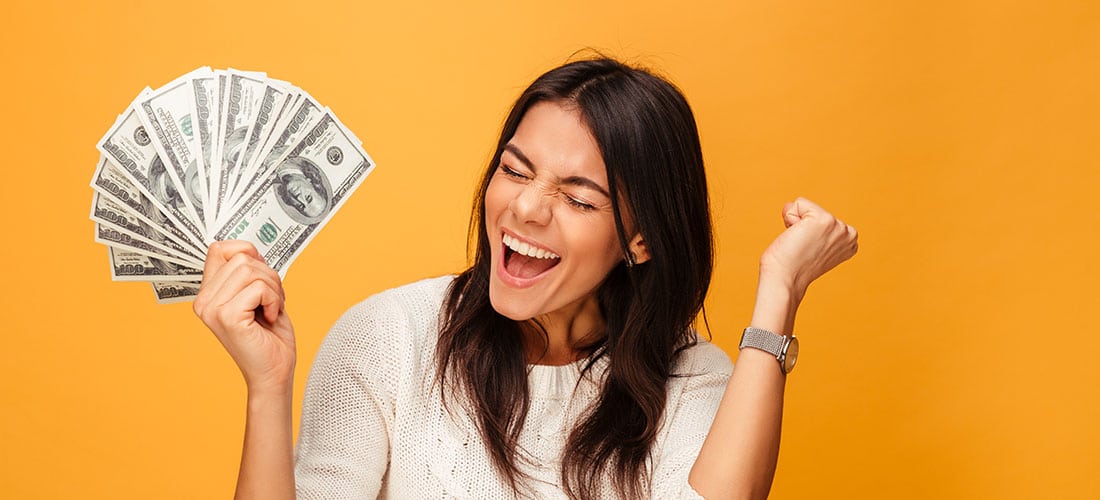 Woman cheering with handful of money